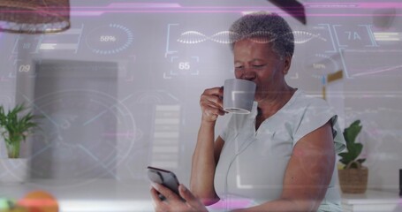 Sipping senior woman wearing light top, holding smartphone and mug at home counter, HUD, copy space