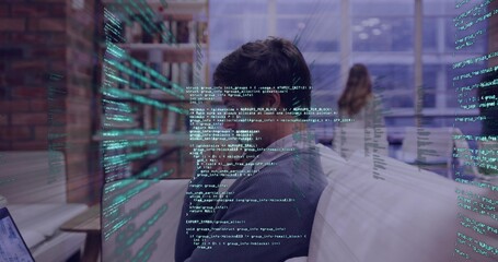 Leaning man wearing sweater focusing on monitor at office, with laptop and holographic code