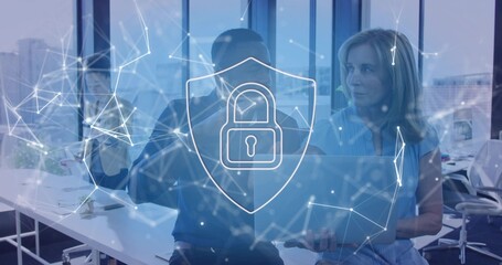 Analyzing three staff in casual wear pointing at laptop at office, showing digital lock overlay