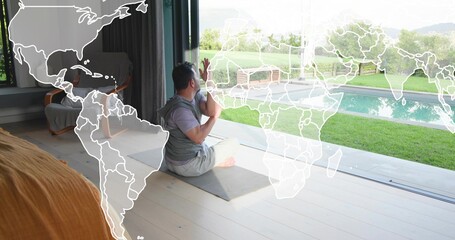 Sitting man wearing gray tee and shorts on yoga mat at home, map overlay showing pool