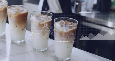 Showing 3 clear glasses layering iced latte on marble cafe counter, digital charts, staff in jacket