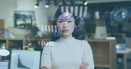 Standing Chinese woman in light knit top crossing arms in modern office, with data overlays