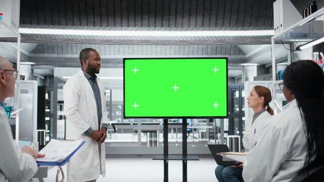 Chroma key display used by lab specialist presenting innovative DNA sequencing project to colleagues. African american man using isolated screen to do briefing for researchers, camera A