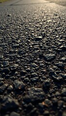 Rough, dark asphalt texture closeup with subtle light reflections,  urban,  dark