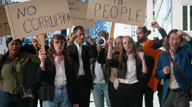 Protesters involved in non-violent rally against corrupted government, using cardboard signs to demand transparency, democracy and reform while expressing dissatisfaction and empowerment. Camera A.