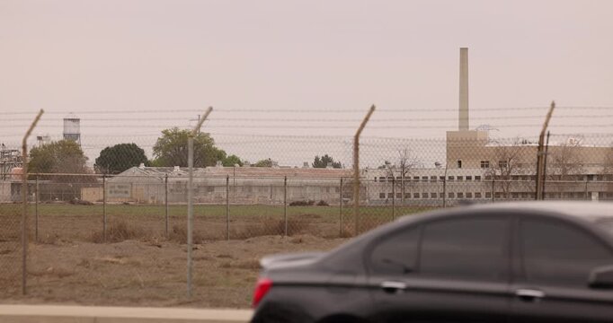 Chino, California, USA - March 1, 2025: Cloudy sun shines on the California Institution for Men State Prison Chino.