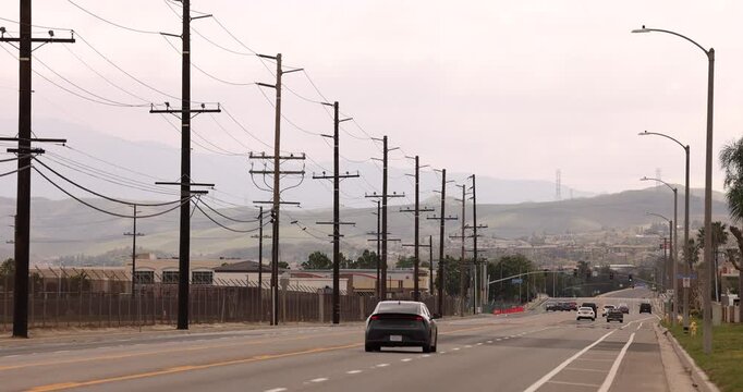Chino, California, USA - March 1, 2025: Afternoon traffic passes southbound on Central Avenue.