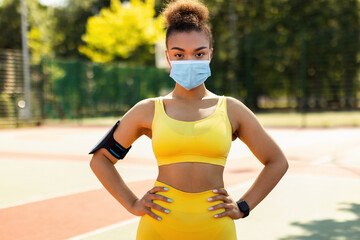 Sport And Quarantine Concept. Portrait of athletic fit black woman wearing surgical medical face...