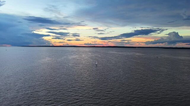 Aerial Establishing View of a Lone Optimist Sailboat on the Paran&aacute; River in Posadas Argentina