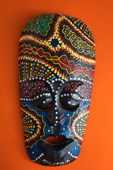 Traditional artisan mask with colorful dot painting from Colombia