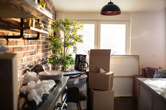 Moving day boxes in cozy loft apartment kitchen
