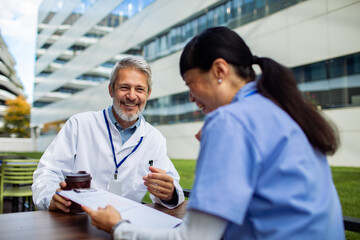 Doctors and nurse meeting outdoors at hospital campus
