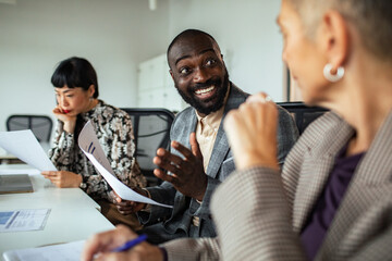 Diverse startup team discussing strategy in modern office