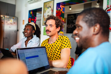 Creative team meeting with laptops in coworking space