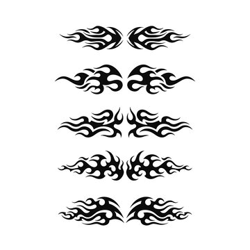 A set of symmetrical black tribal flame decals on a white background, featuring sharp, fluid curves ideal for automotive vinyl stickers, tattoos, or aggressive graphic design.