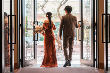 Wedding reception, after-party, bride and groom appearing in wedding color dresses, dressed-up...