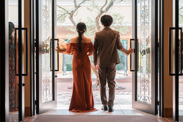 Wedding reception, after-party, bride and groom appearing in wedding color dresses, dressed-up...