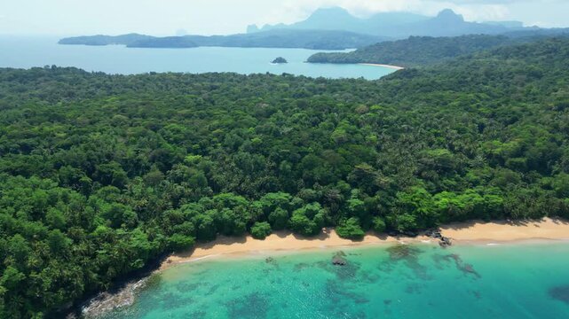 Aerial view of beautiful Macaco beach revealing the island's coastline from Prince Island,S&atilde;o Tome,Africa. Drone shot side
