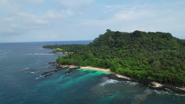 Aerial view rising over caf&eacute; beach at Ilheu das Rolas,revealing the local village at sunny day in S&atilde;o Tom&eacute;, Africa
