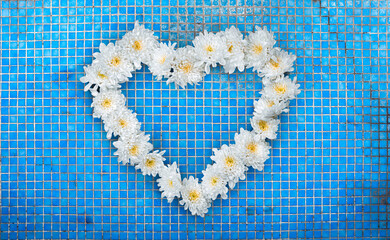White Flowers Heart on Ceramic Mosaic Tile Background. Valentines Day and Love Wallpaper Background. File with Clipping Path.