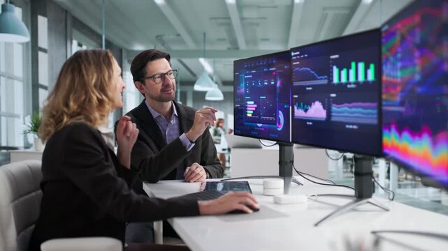 Financial Analysts Study Computer Dashboard, Analyzing Data