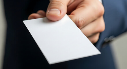 Hand offering a blank business card for contact information.