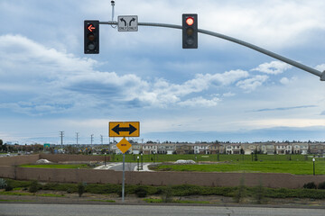 Truck driver waits at a traffic signal in Pleasant Grove California while preparing for the next haul during an overcast day