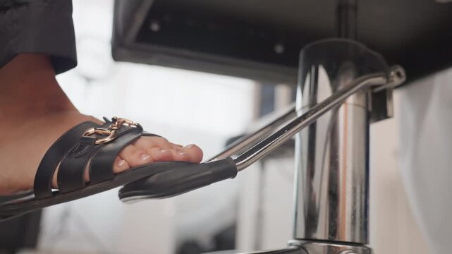 close up sandal foot chair lever, sunlight filtering through sheer curtains, chrome column and pedal in foreground, casual sandal strap pressing adjustment mechanism, modern kitchen island and blurred
