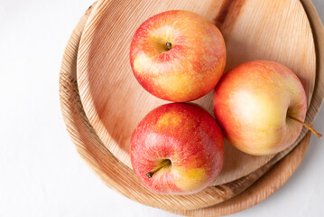 Red apple fruit (Gala apple) in natural plate on white background, Top view