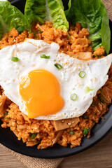 Korean kimchi fried rice with fried egg and spring onion on top