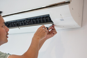 Electrician man repair and maintenance air conditioner