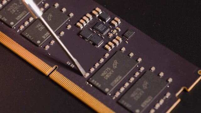 Macro Shot of Metal Tool Repairing Computer RAM Memory Module