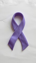 A purple awareness ribbon made of clay on a clean white background, symbolizing support for various social causes and health awareness campaigns.