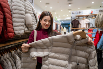Woman choosing a light jacket in clothing store