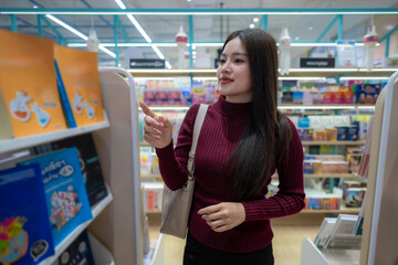 Asian woman choosing book in bookstore
