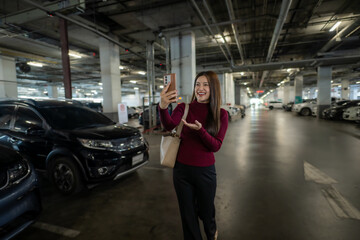 Woman vlogging with phone in underground parking lot