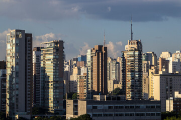 Obraz premium The exterior of modern condominiums is used full of glass, including sliding doors, windows and balconies. to avoid feeling cramped in Sao Paulo city
