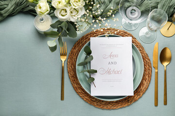 Beautiful wedding table setting with invitation card, glasses, flowers and eucalyptus branches on...