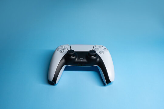 Modern game controller on blue background with copy space, 3:2 - Powered by Adobe