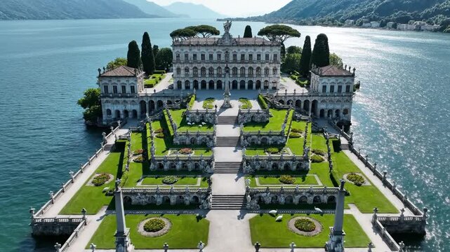 Opulent lakeside palace on a grand estate with terraces beside calm blue water, flanked by mountains