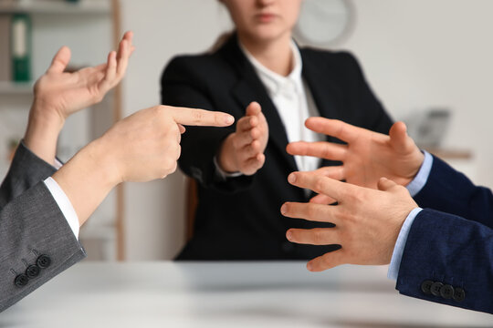 Hands of arguing clients at mediator's office, closeup