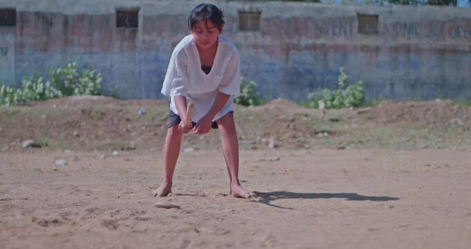 Traditional Indian Game Gilli Danda Played by Village Girl