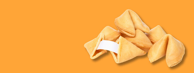 Obraz premium Fortune cookies stacked together on a vibrant orange background
