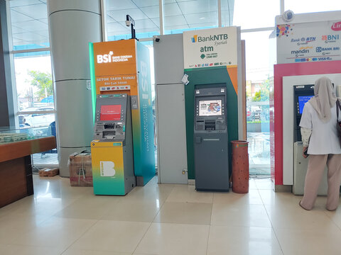Female doctor at atm machine, BSI and NTBs bank atm machine at Mataram Citys hospital 