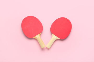 Red ping pong rackets on pink background