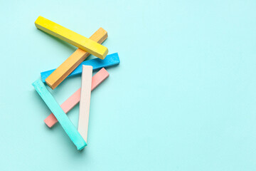 Obraz premium Pieces of colorful chalks on blue background