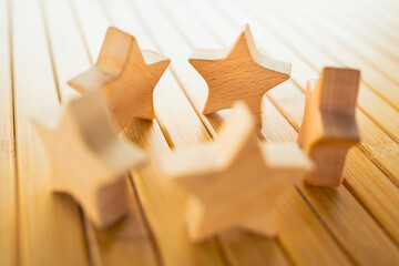 Wooden star figures arranged on table representing customer rating, product review, service quality...