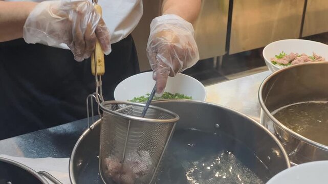 Vietnamese Soup Method is unique. Cook follows Vietnamese Soup Method at kitchen. Using Vietnamese Soup Method helps prepare delicious beef noodle soup with fresh herbs and hot bouillon.