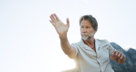 Mature man, tai chi and martial art with space for spiritual healing, zen or wellness in nature. Male person, reiki or chakra with practice in motion or movement for channeling body energy or balance