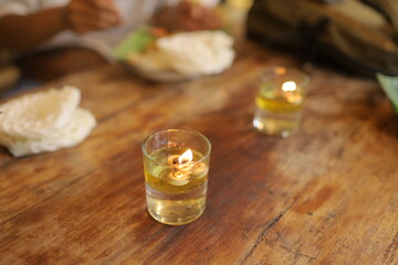 Cozy ambiance with lit candles on rustic wooden table